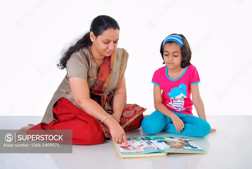 Mother teaching her daughter, Pune, India.