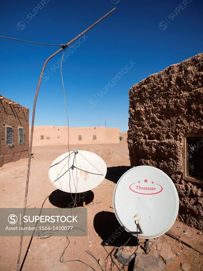 Satellite dish between buildings in village of Khamlia, Morrocco.