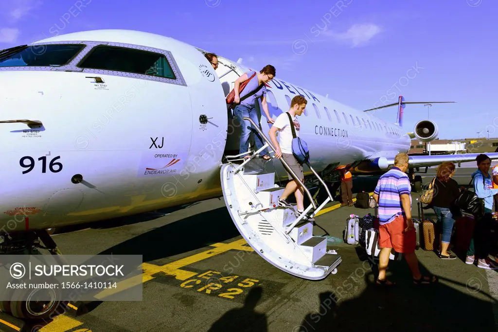 Small jet disembark passengers stairway jfk airport new york.