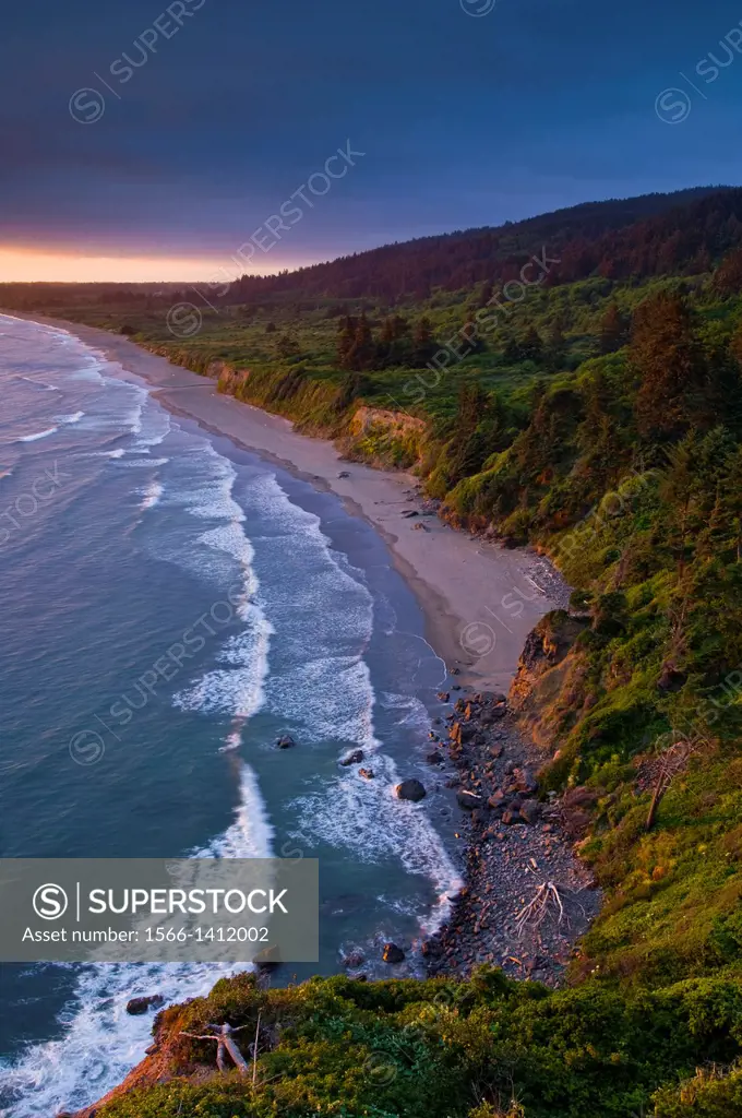 Sunset light and clouds over the hills above Enderts Beach, near Crescent City, Redwood National Park, California.