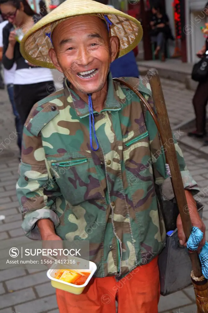 China, Beijing, Dongcheng District, Nanluoguxiang, hutong, historic, Asian, man, street sweeper, city worker, conical coolie hat, smiling,.