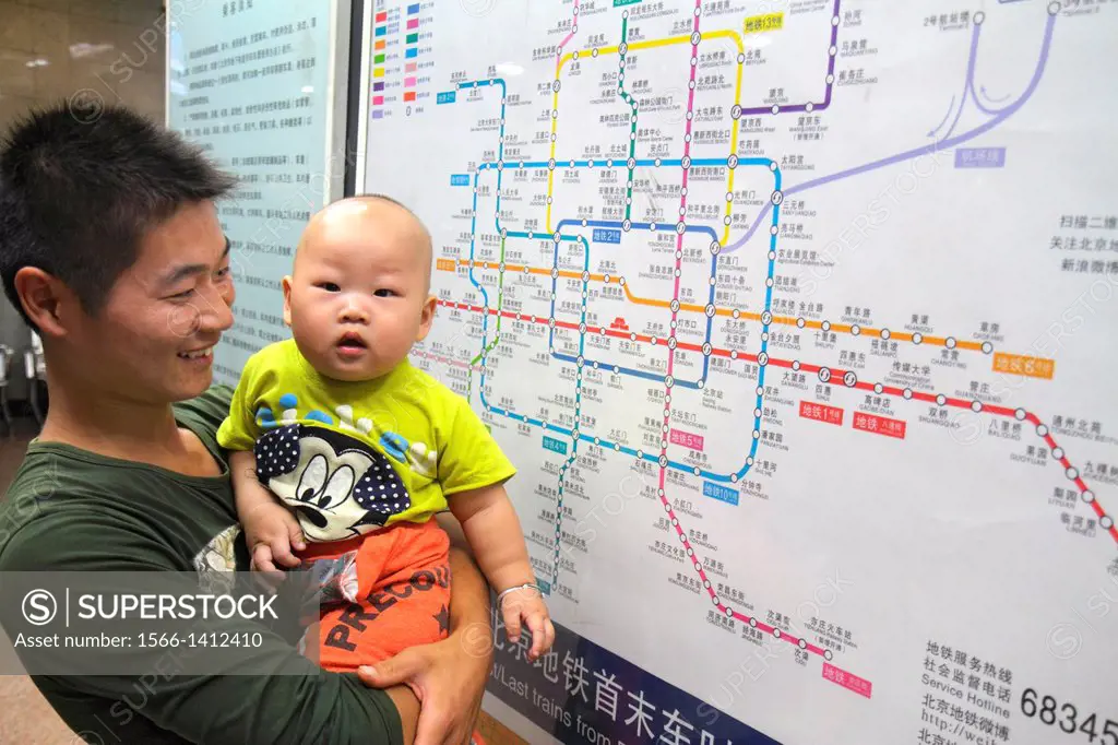 China, Beijing, Tian´anmen West Subway Station, Line 1, public transportation, Asian, man, father, boy, son, holding, route map, sign, information, Ch...