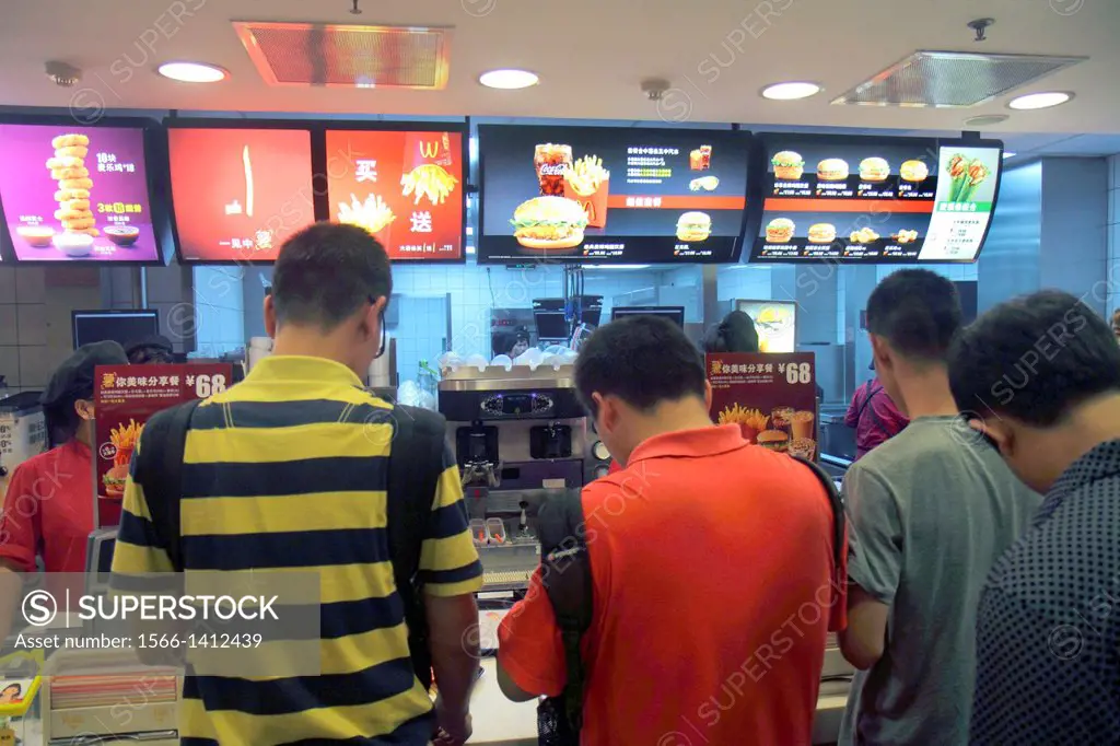 China, Beijing, Dongzhimen, McDonald´s, fast food, restaurant, inside, interior, counter, customers, Asian, man, menu, Chinese characters hànzì pinyin...