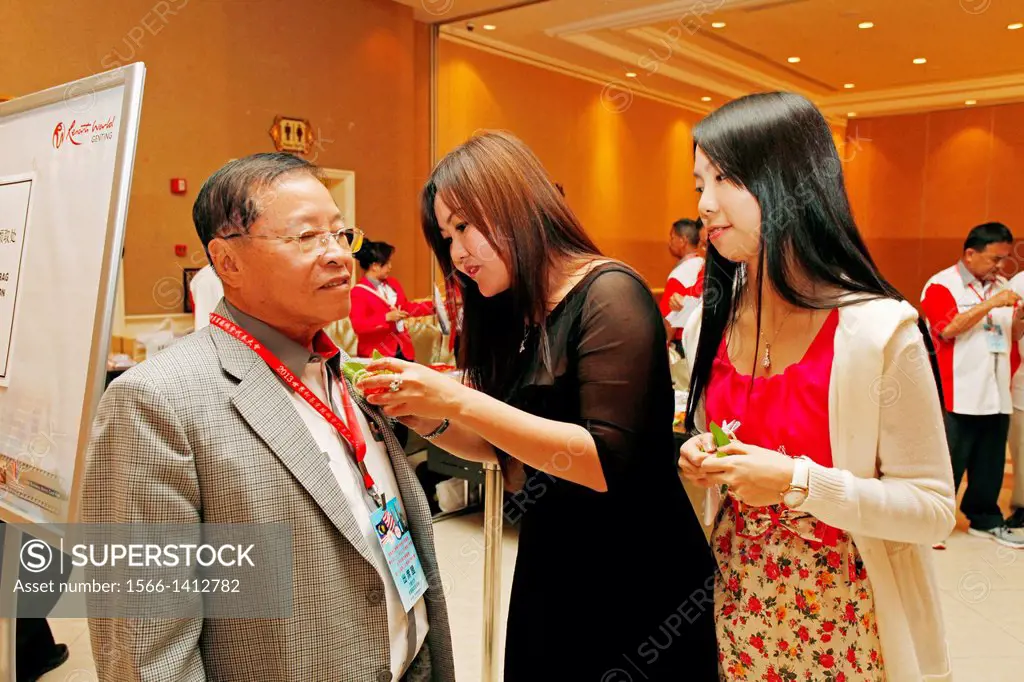 Pinning flower for VIP during 17th Anniversary World Chai´s Clan at Genting Highland Convention, Malaysia.