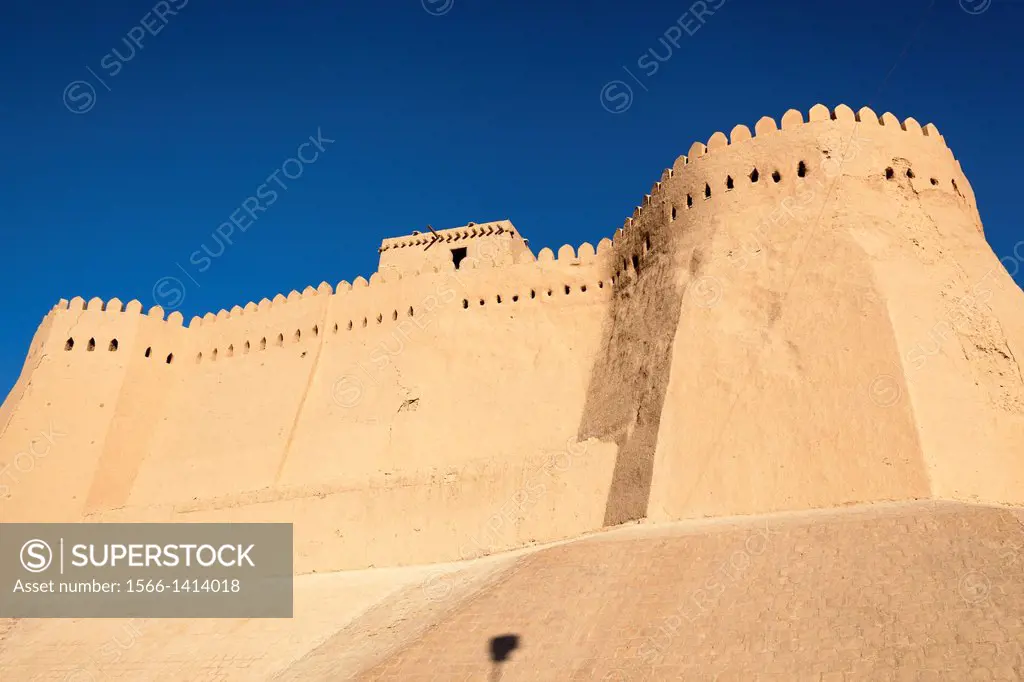 Akshi Bobo, a tower of Kunya Ark in centre, and outer wall of Ichan Kala, Khiva, Uzbekistan.