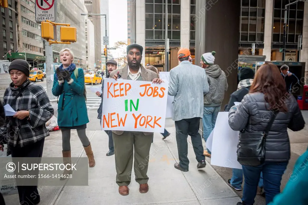 Bank or America workers and their supporters protest in front of a Wall Street branch of the bank in New York. The activists are protesting the replac...