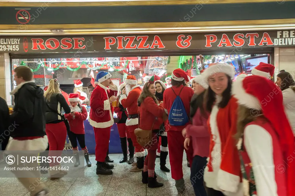 Christmas revelers arrive at Pennsylvania Station for the annual SantaCon in New York. Santacon, primarily a pub crawl in Santa and other Christmas re...