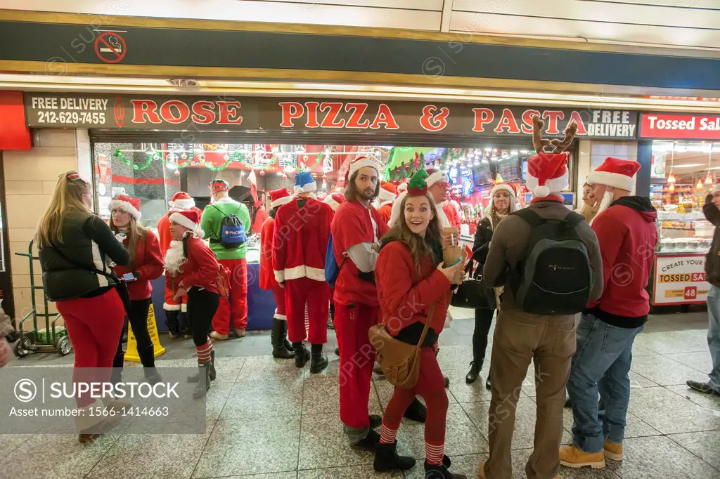 Christmas revelers arrive at Pennsylvania Station for the annual SantaCon in New York. Santacon, primarily a pub crawl in Santa and other Christmas re...