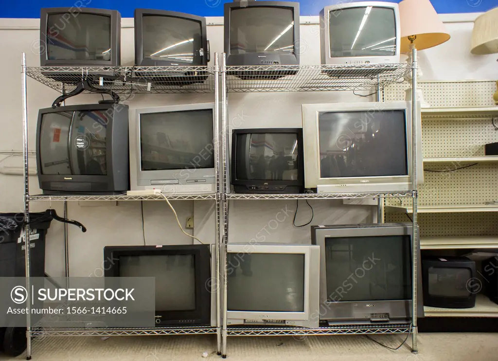 Second-hand CRT analog television sets are seen lined up for sale in a thrift store in New York. Three years ago the country switched from analog to d...
