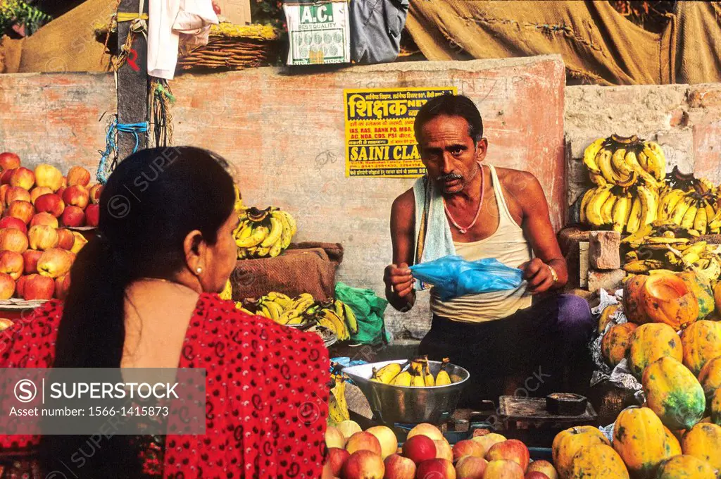 Woman shopping fruit at market, Bikaner, Rajasthan state, India
