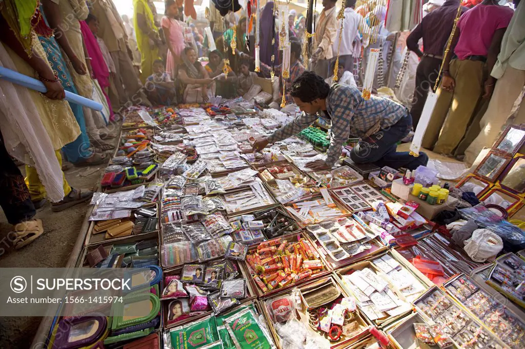 Shopkeeper selling household goods for daily use. Khalwa, Madhya Pradesh, India.