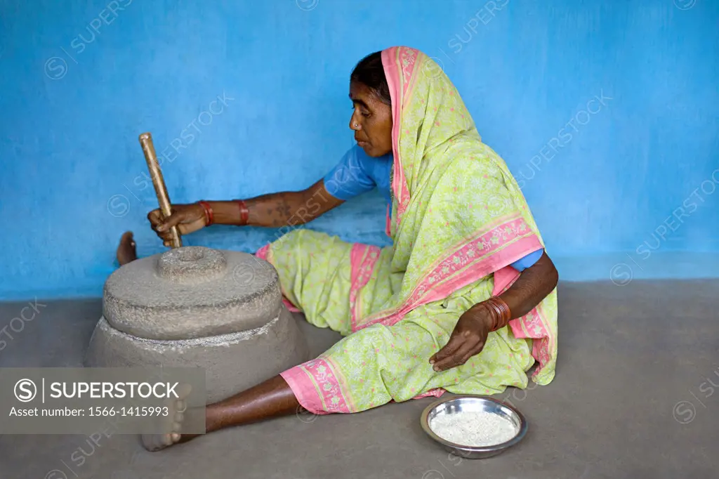 Woman working on a grinding stone, Gadchiroli, Maharashtra, India.