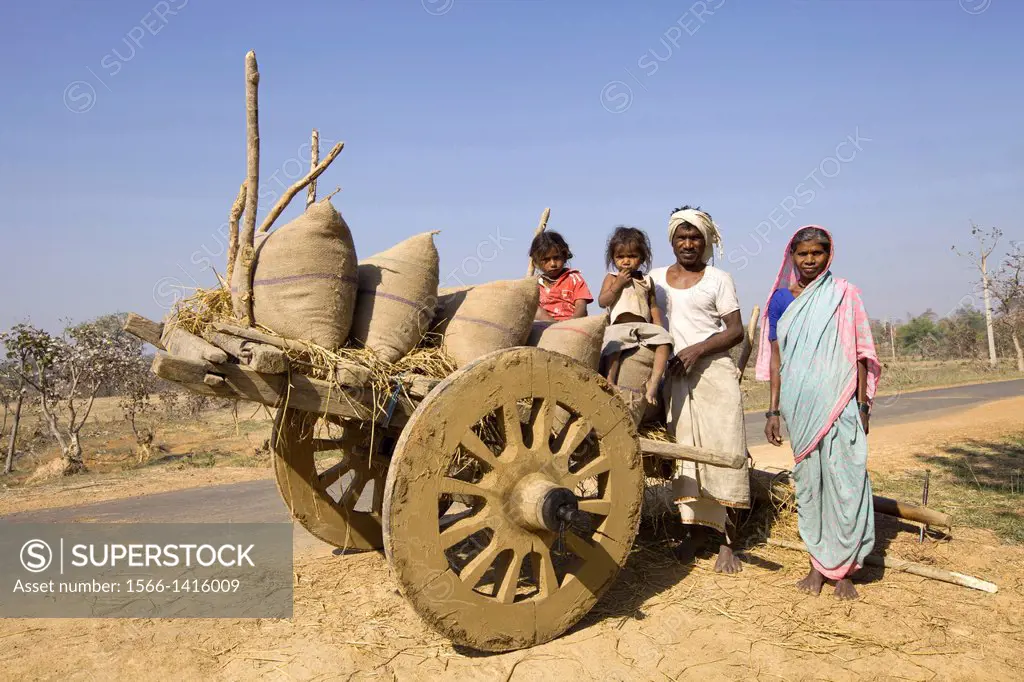 Tribal family of man, woman and two children with cart, Gond tribe, Gadchiroli, Maharashtra, India.