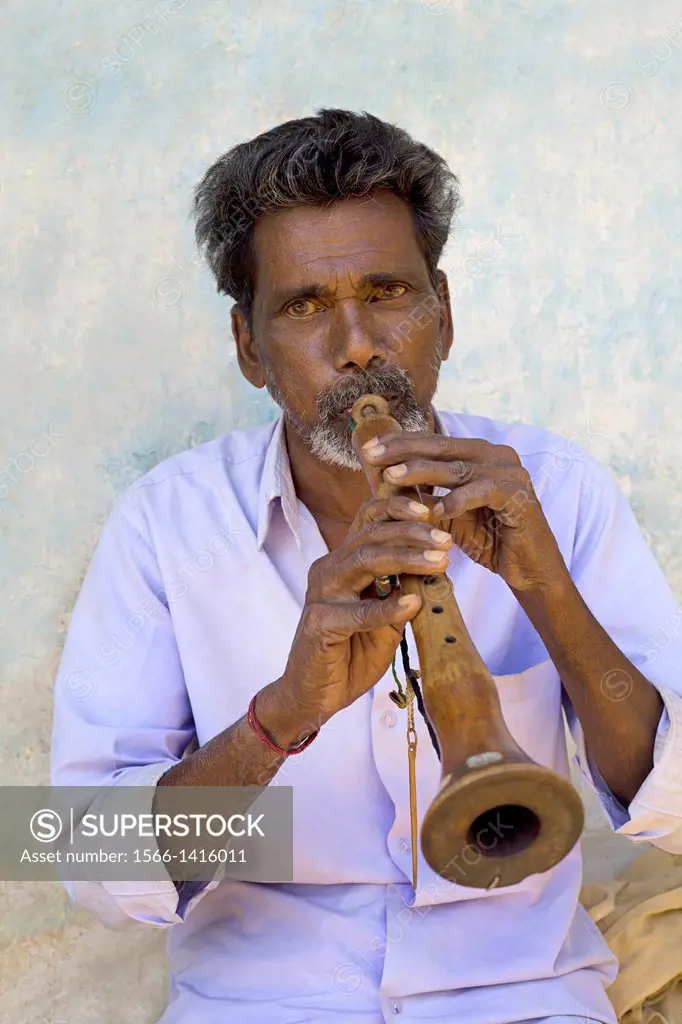 Musician playing Shenai ( double reed ), Gond Tribe, Gadchiroli, Maharashtra, India.