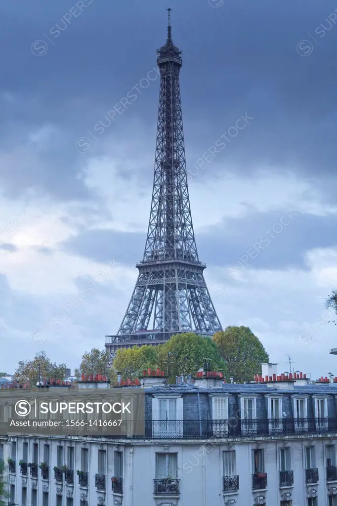 The Eiffel Tower rises above the rooftops on a dreary November morning.