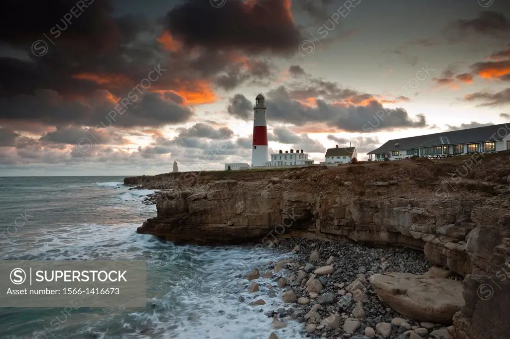 A stormy end to the day as the English Channel laps at the foot of the lighthouse on Portland Bill near to Weymouth in Dorset.