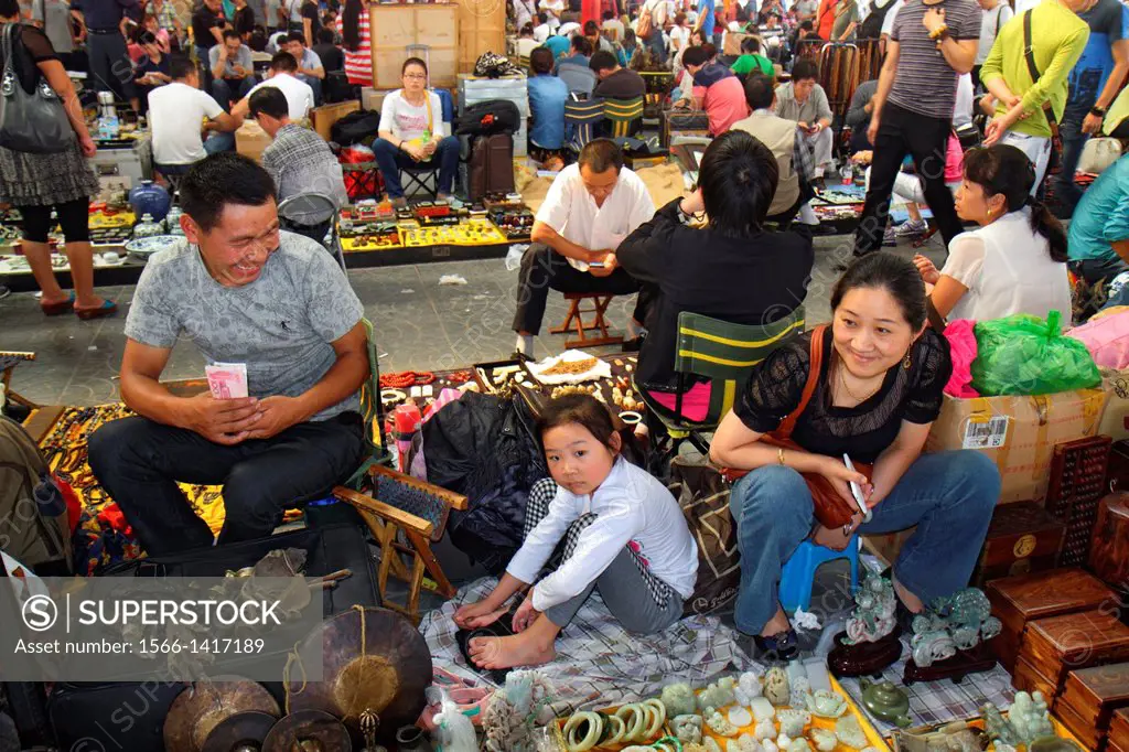 China, Beijing, Chaoyang District, Panjiayuan Weekend Dirt Flea Market, shopping, selling, buying, display, sale, vendor, customer, ornamental stone, ...