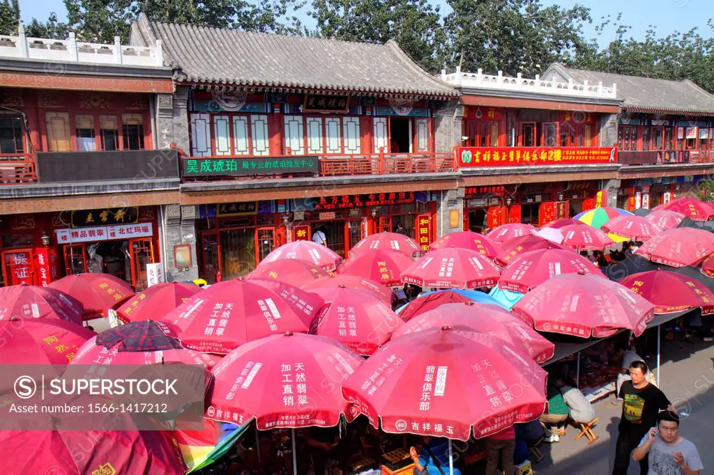 China, Beijing, Chaoyang District, Panjiayuan Weekend Dirt Flea Market, shopping, selling, buying, display, sale, vendor, umbrella, Chinese characters...