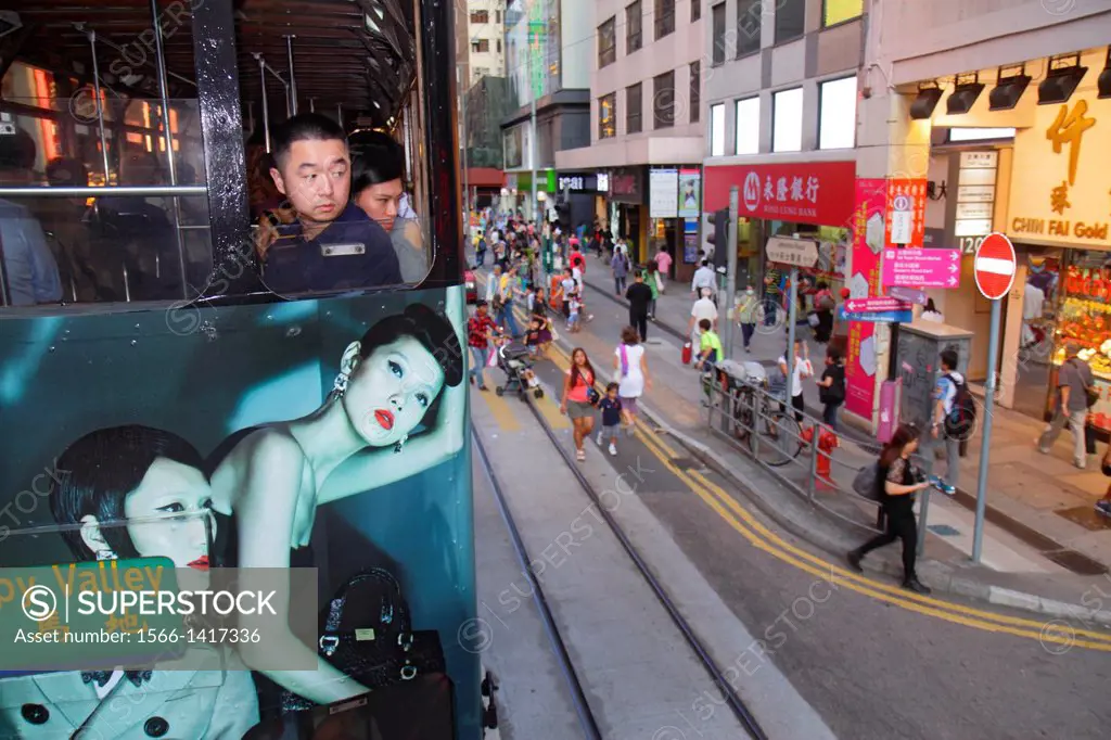 China, Hong Kong, Island, Admiralty, Hennessy Road, businesses, pedestrians, double decker tram Tramways, public transportation, Asian, man, rider, pa...