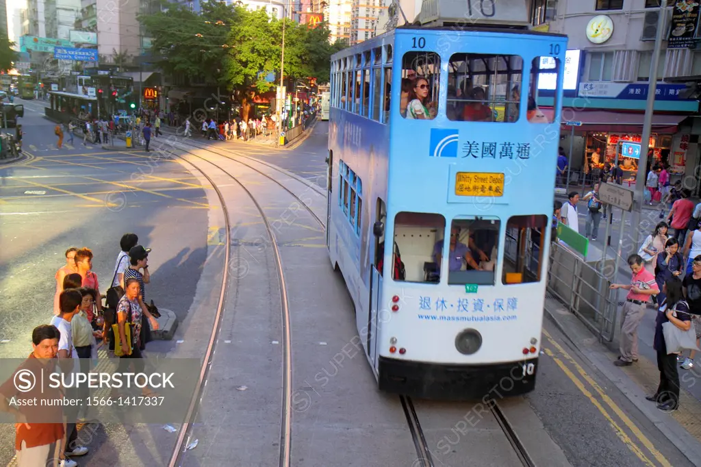 China, Hong Kong, Island, Wan Chai, Hennessy Road, businesses, pedestrians, double decker tram Tramways, public transportation, Asian, woman, rider, p...