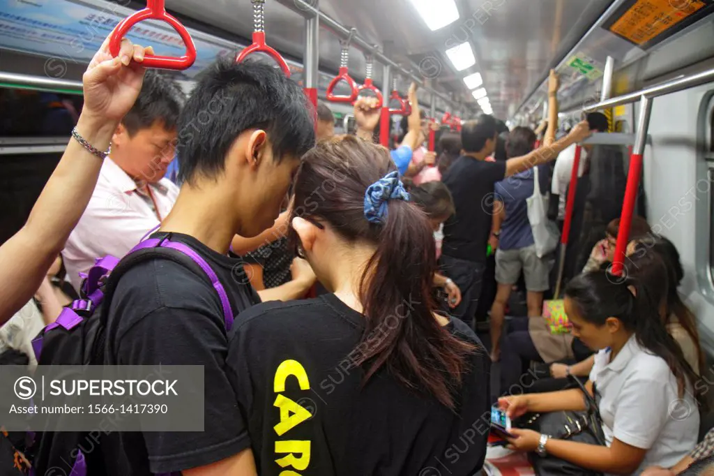 China, Hong Kong, Island, MTR, North Point Subway Station, public transportation, train cabin, passengers, riders, sitting, standing, Asian, teen, boy...