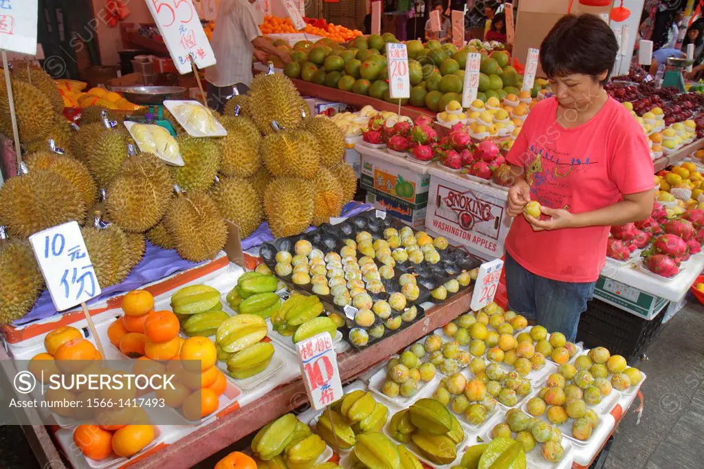 China, Hong Kong, Kowloon, Sham Shui Po, produce vendor, sale, display, fruit, durian, starfruit, carambola, Asian, woman, employee, manager, owner, C...