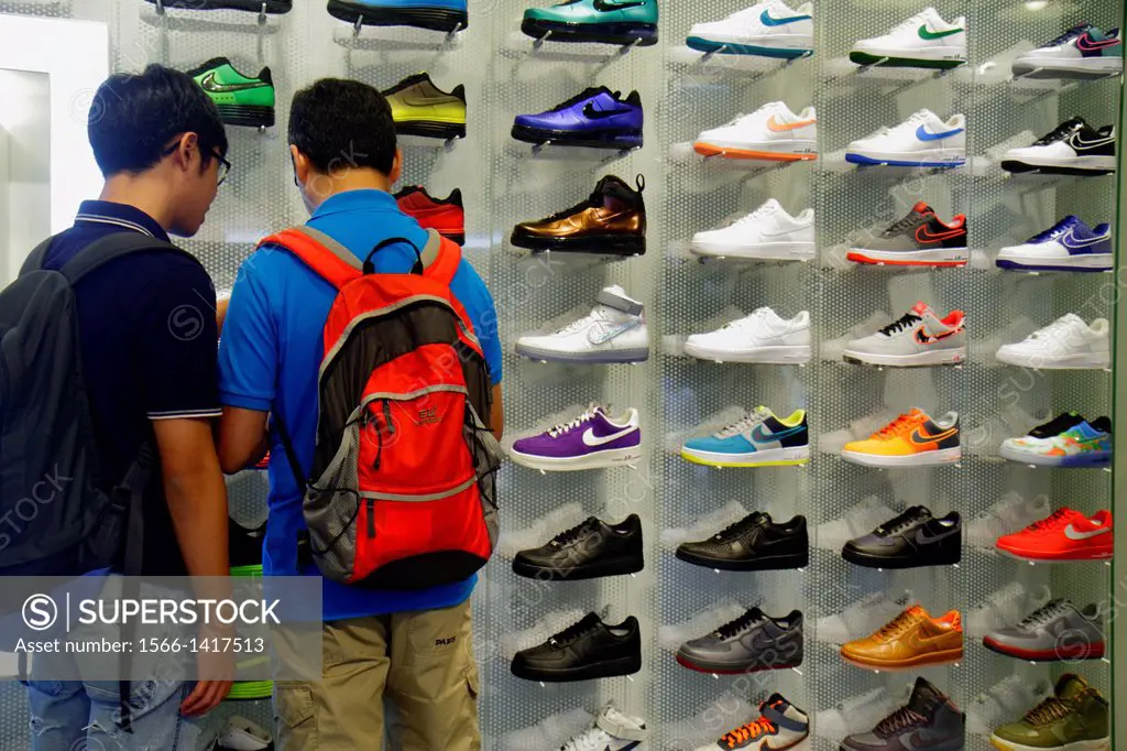 China, Hong Kong, Kowloon, Mong Kok, Fa Yuen Street, Sneaker Street, shopping, fashion, athletic shoe store, inside, sale, display, Asian, teen, boy, ...