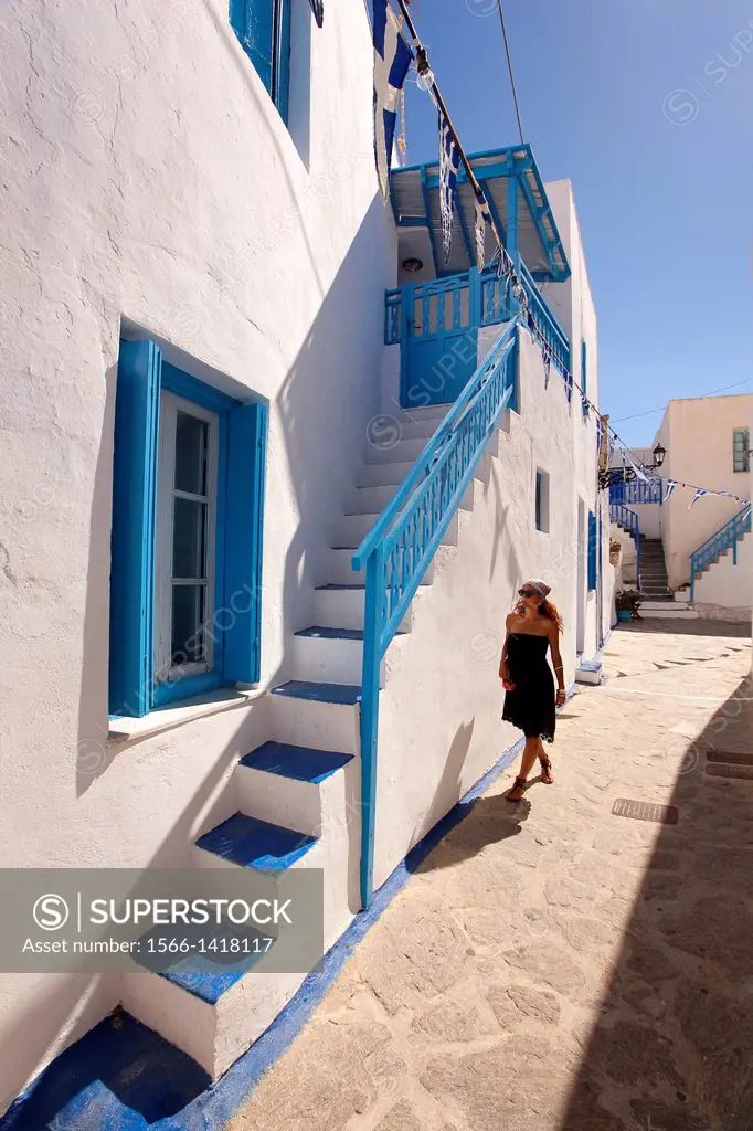 Woman walking in Chora, the town center, Plaka, Milos, Cyclades Islands, Greek Islands, Greece, Europe.