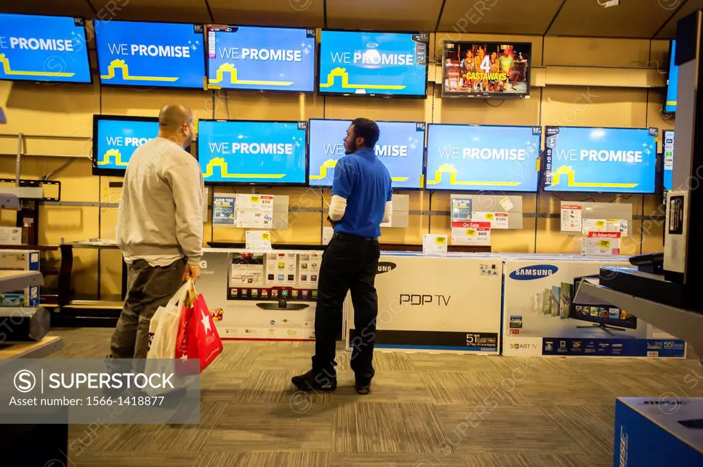 Flat-screen televisions on sale in a Best Buy electronics store in the Queens borough of New York. The retailer is in a life and death struggle with A...