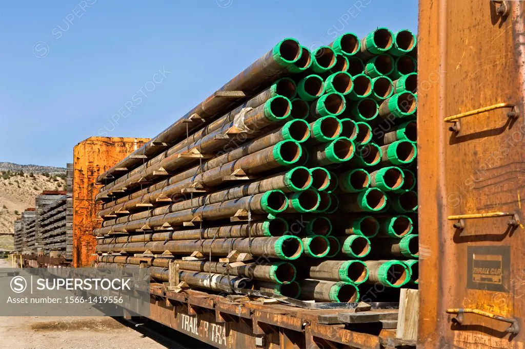 Stacked drill pipe on rail cars in Colorado.