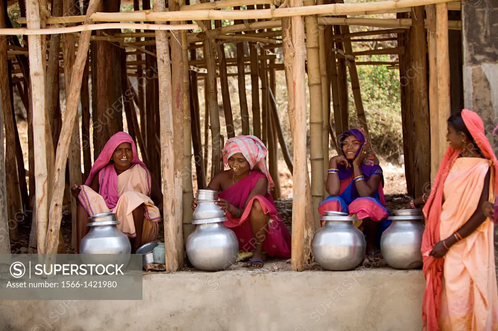 Tribal women selling mahua liquor countrymade liquor, Orissa, India.