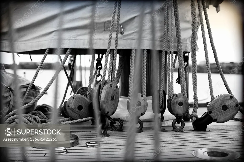 Closeup of a classic sailboat deck with pulleys, ropes, and sails at the Port Mahon, Menorca, Balearic Islands, Spain.