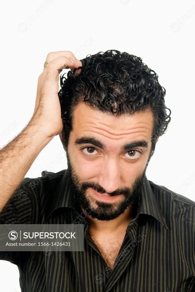 25 years old Middle Eastern man confused and scratching his head.