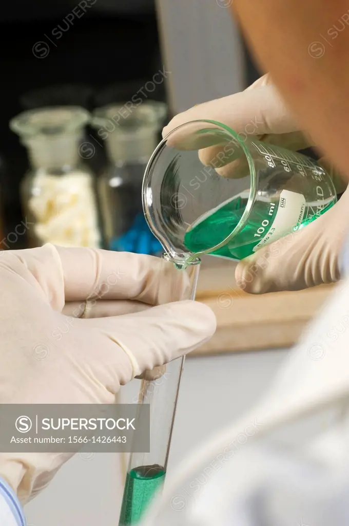 Chemist mixing solutions in a lab.