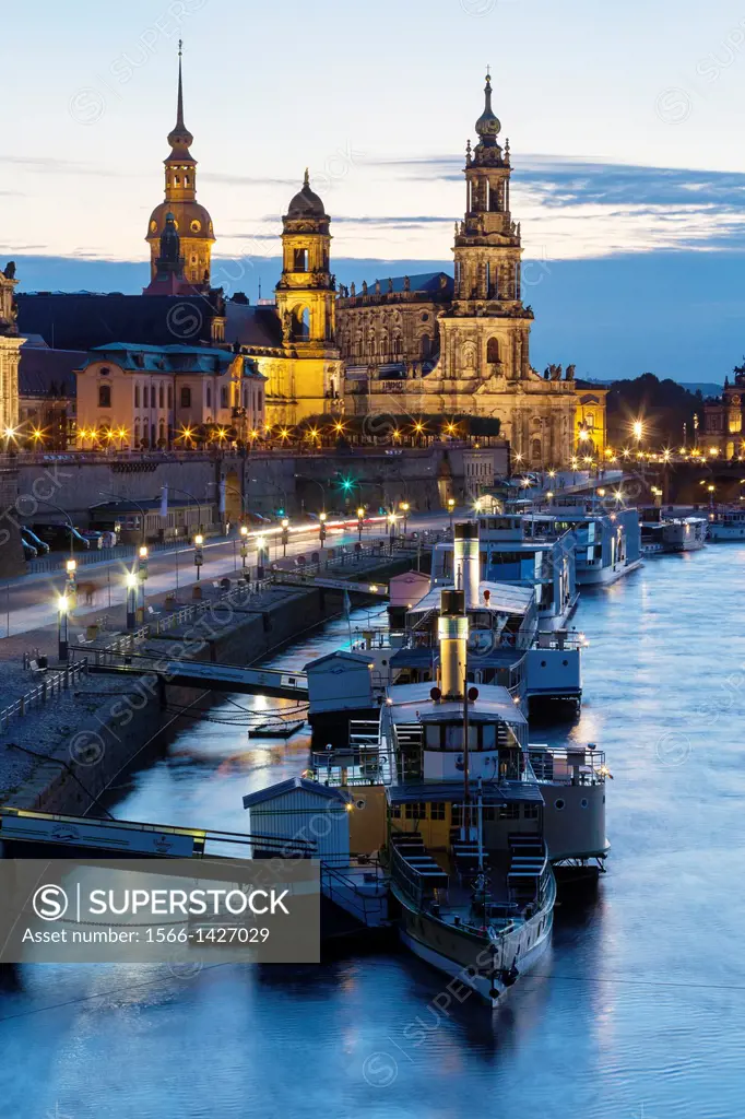 river Elbe with ships, Dresden Castle, appellate court and Dresden Cathedral at night, Dresden, Saxony, Germany.