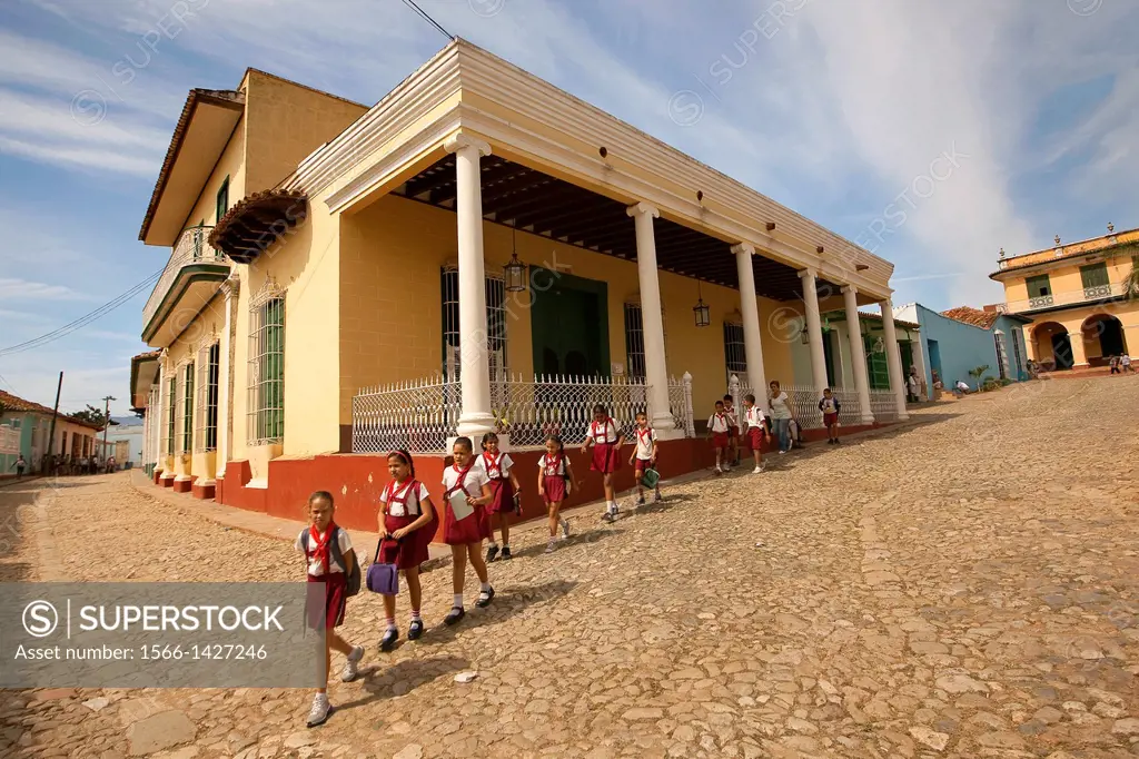 School kids walking on the Main Square-Plaza Mayor, Trinidad, Sancti Spiritus Province, Cuba, West Indies, Central America.