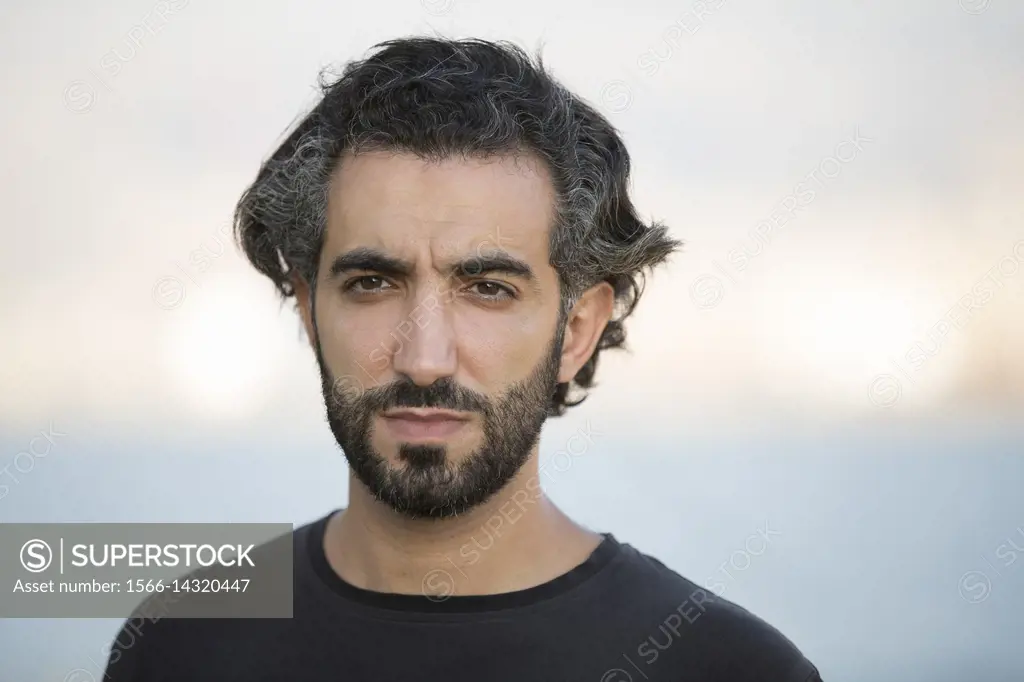 Portrait of a Middle Eastern man outdoors.