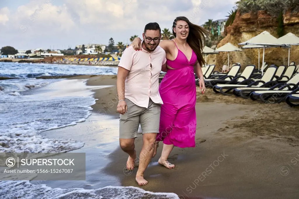 Chersonissos, Crete, Greece, couple walking on beach, vacations