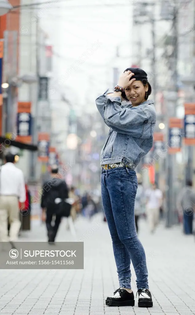 Japanese Girl poses on the street in Machida, Japan. Machida is an area located in Tokyo.