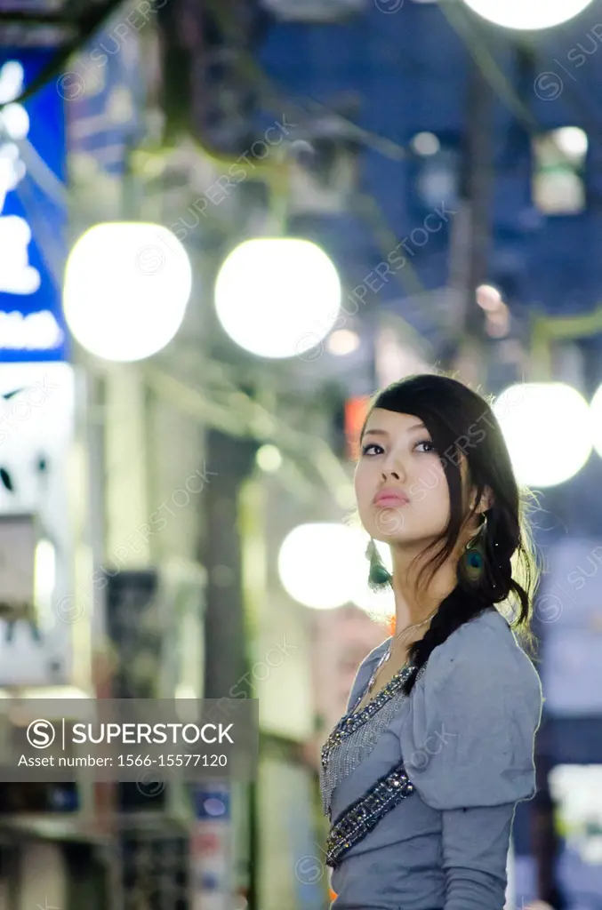 Japanese Girl poses on the street in Nakameguro, Japan. Nakameguro is a town located in the nice area of Tokyo.
