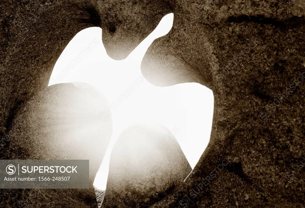 A light passing through a dove cut in a stone