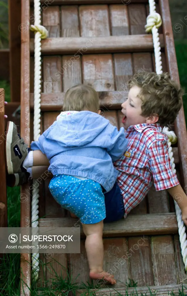 Baby and brother on ladder