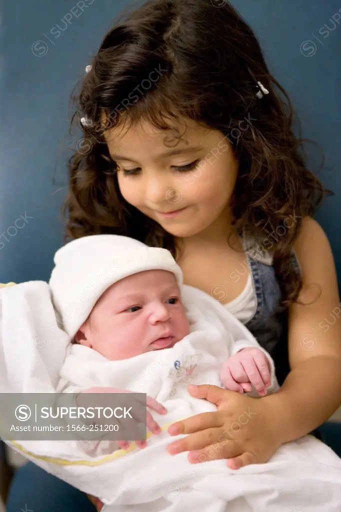 Little sister with newborn baby