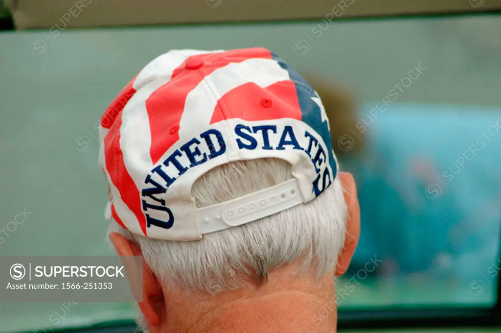 Senior man with flag of the USA on hat at event
