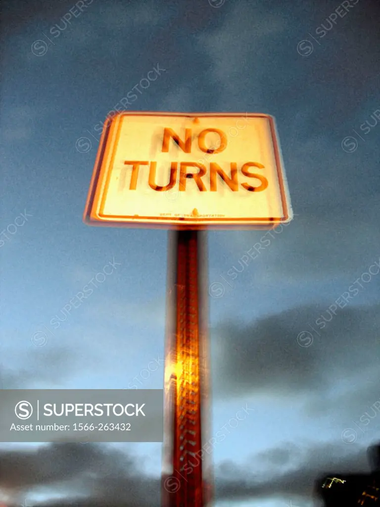 Blurred Street sign ´No Turns´ shot against a dusk sky gives a surreal effect that seems to emanate a cosmic energy.