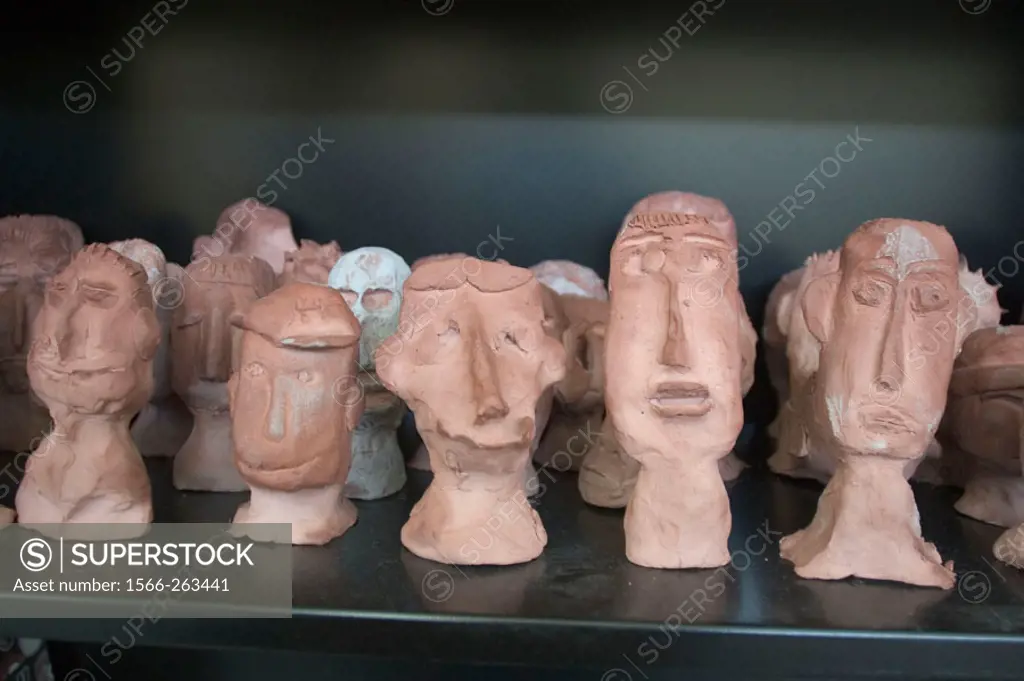 Clay sculptures of little comic heads, created by high school students in art class.