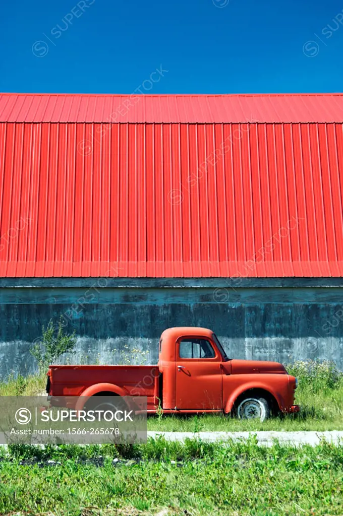 The color of red in an old truck and barn roof near Isle de Chênes, Manitoba. Canada.