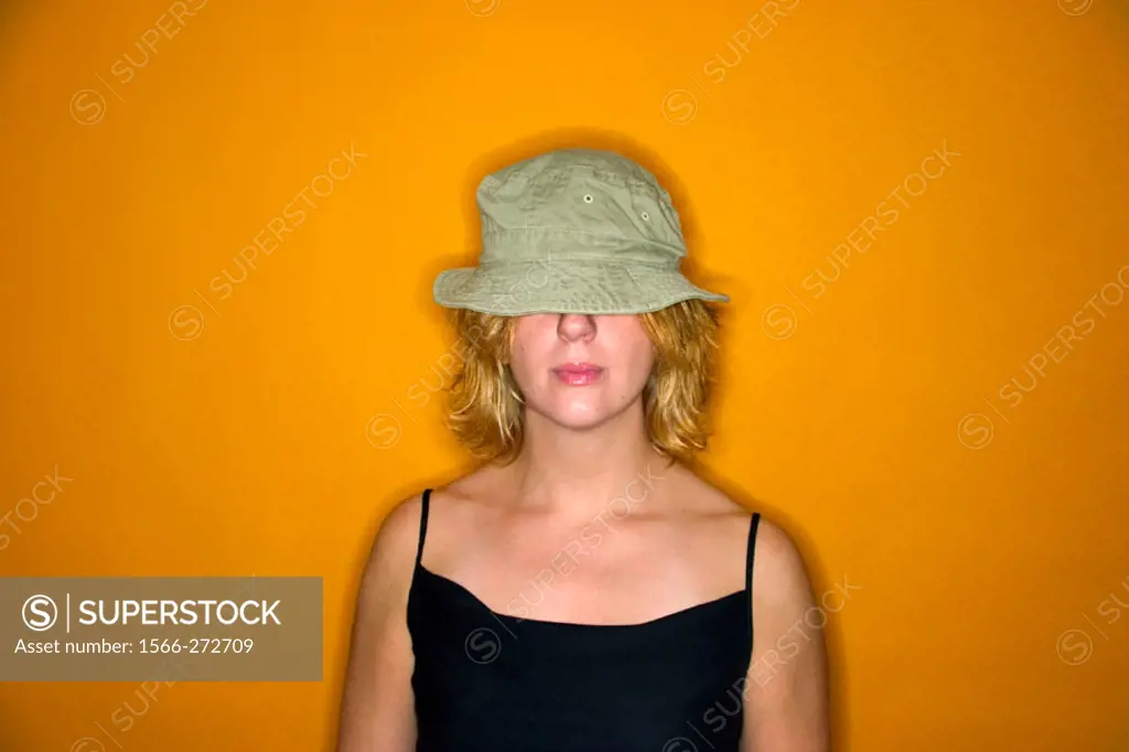 Young blond woman wearing a hat that covers her eyes