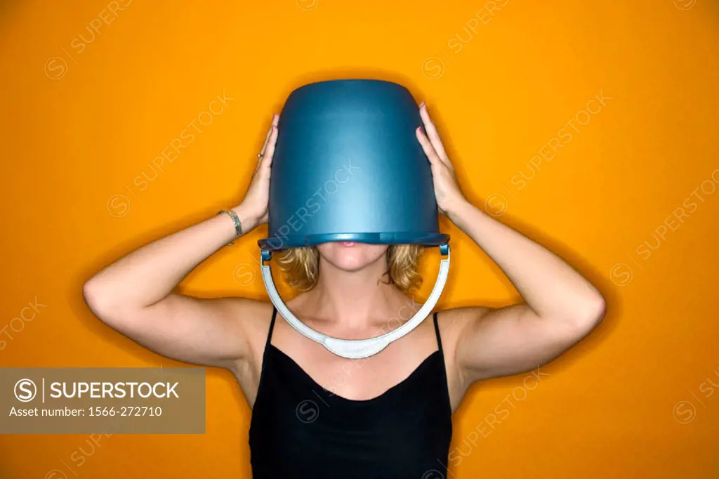 Young blond woman wearing a blue bucket on her head that covers her eyes