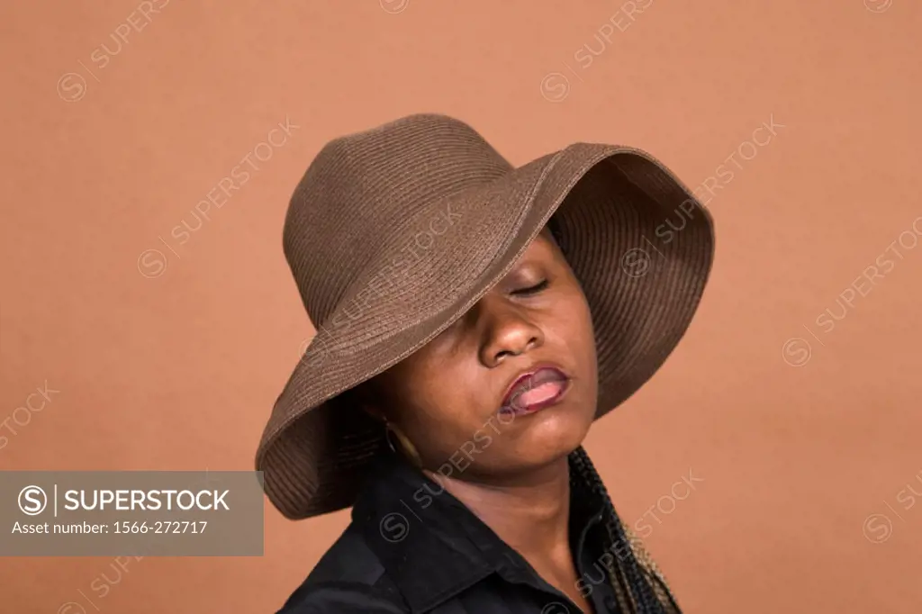 Young black woman, wearing a hat, posing